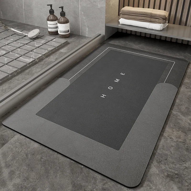 Blue oval blended bathroom floor mat on tiled floor next to a bath.