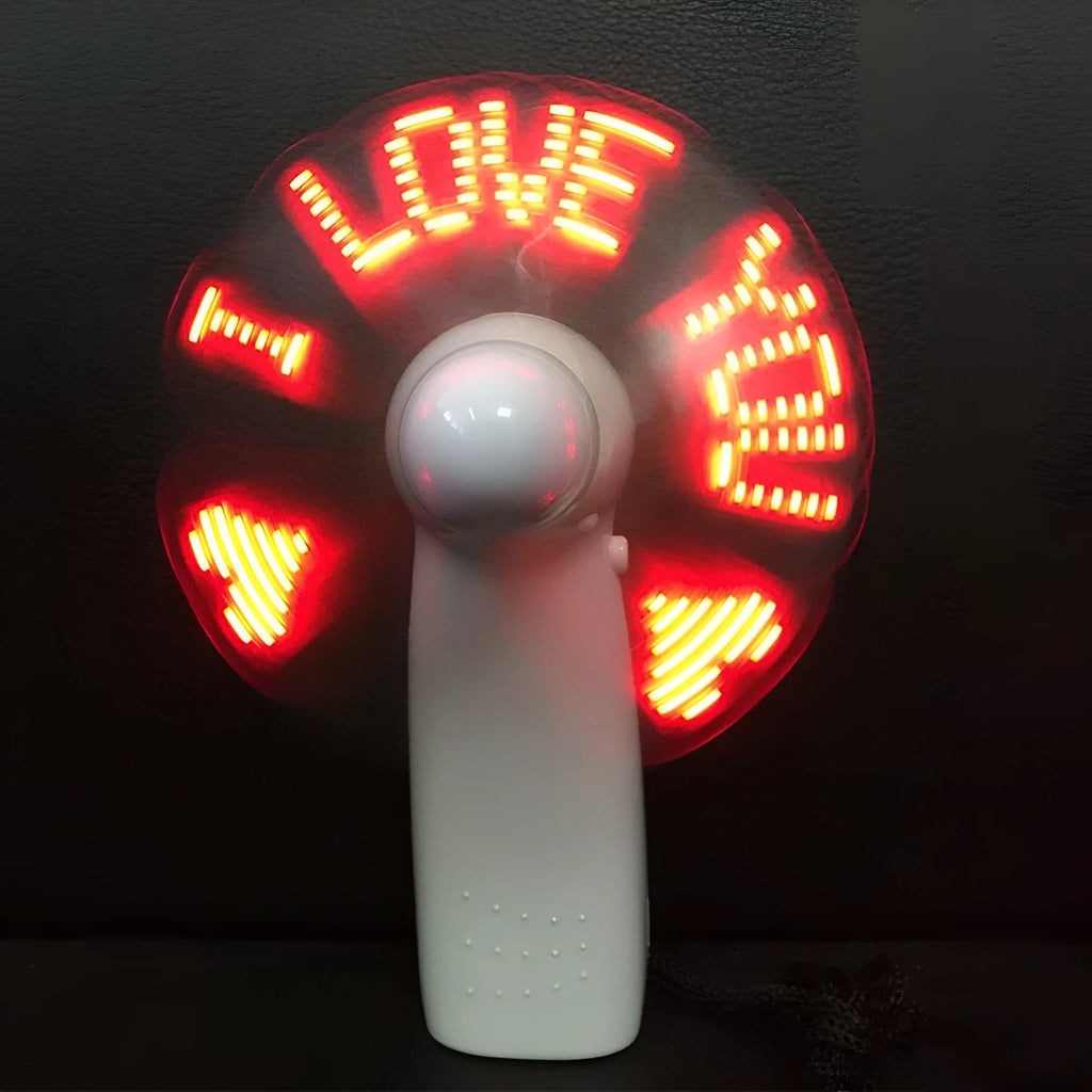 White handheld mini fan with blue and red LED love pattern lights flashing on front
