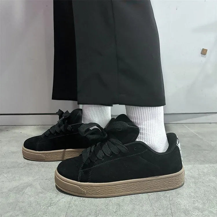 Black retro low-top sneakers with lace-up front, waterproof platform, and round toe design