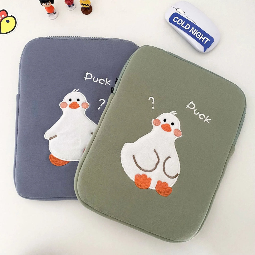 Blue cotton tablet case with embroidered cartoon duck design and a zipper, sized for an iPad.