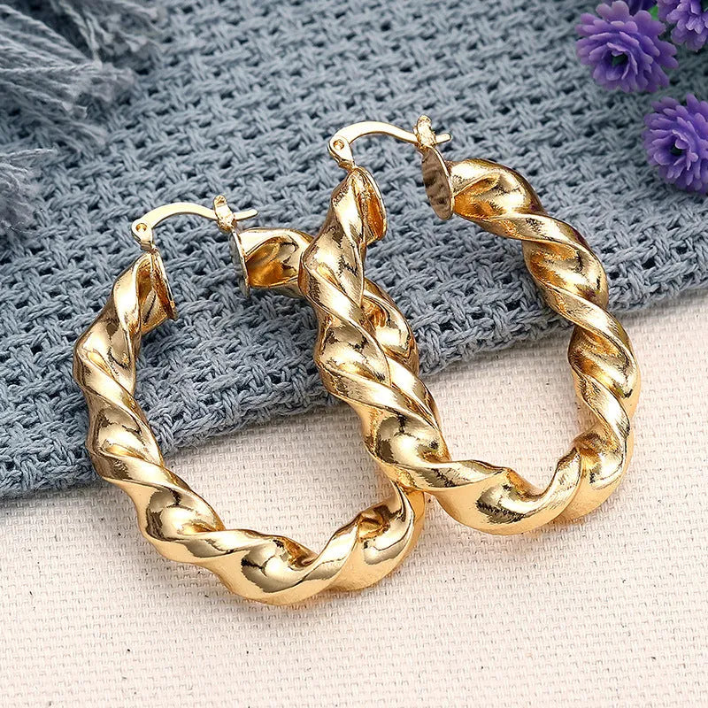 Women's geometric ring design ear clips in copper with electroplated finish showing drop-shaped silhouette