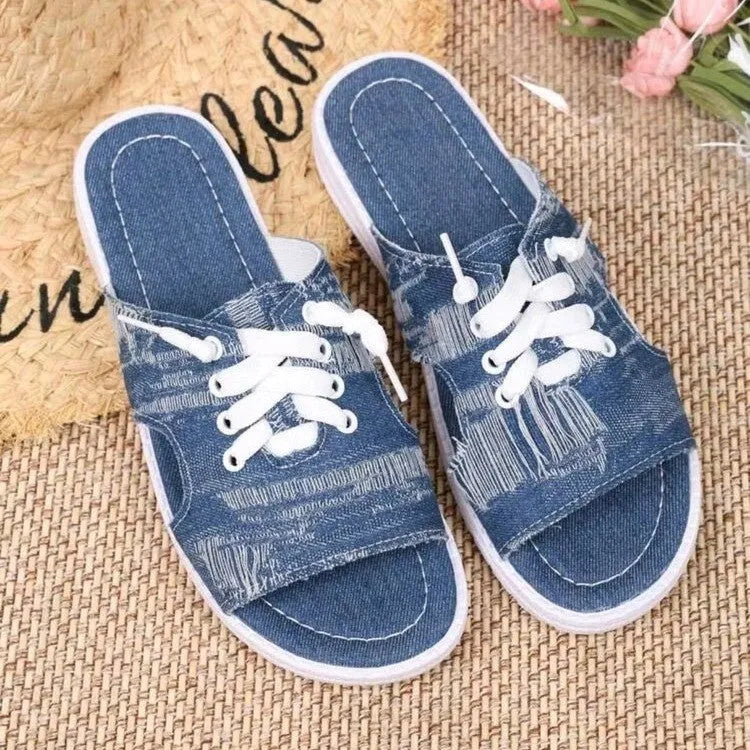 Blue Roman style women's canvas slippers with cloth upper and rubber sole.