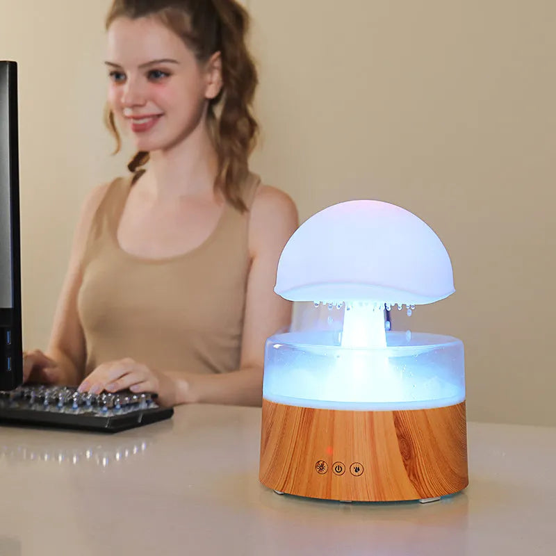 White cloud-shaped aromatherapy humidifier with LED lights and simulated raindrops.