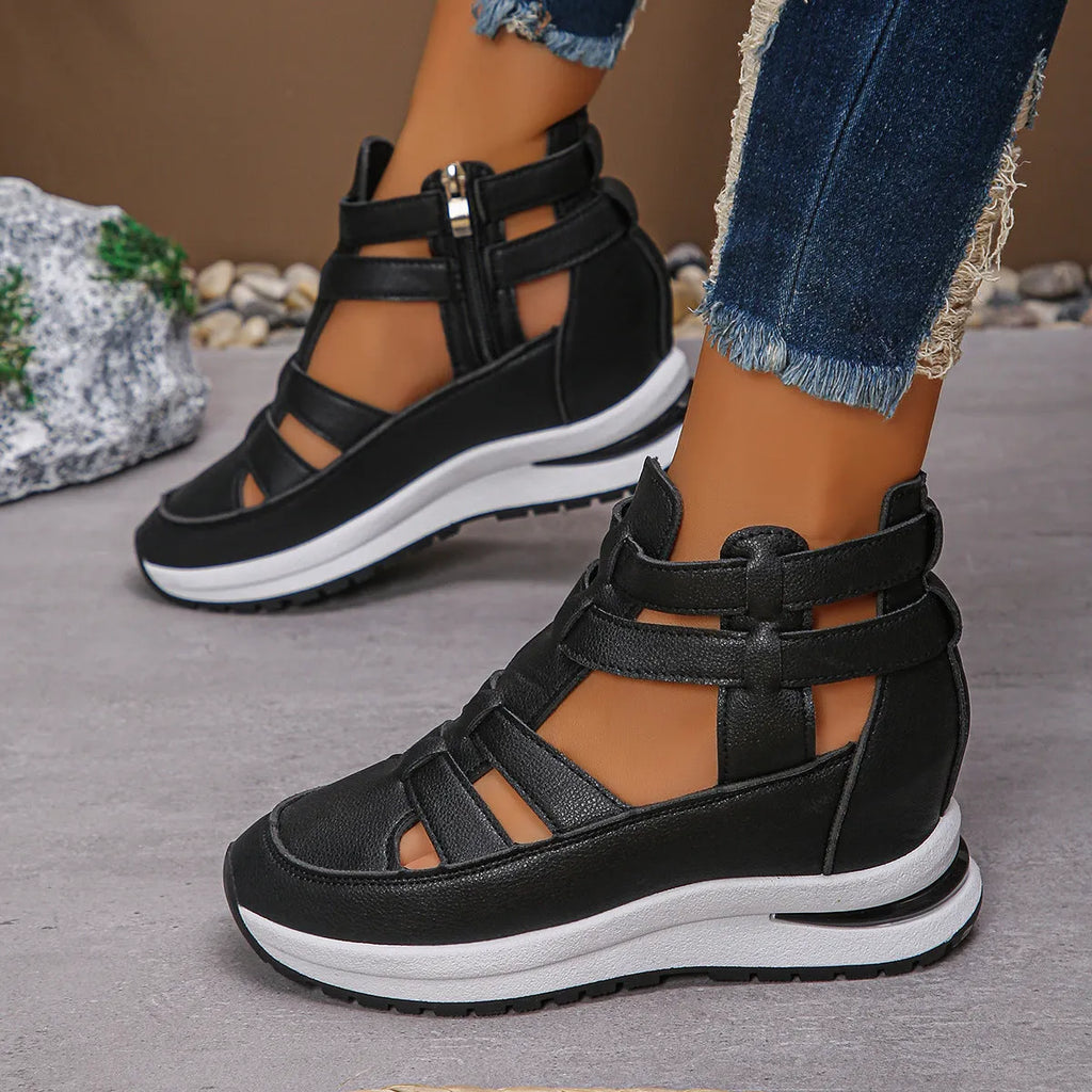 Black women's platform sandals with close toe, hollow-out sides, and a Velcro strap.