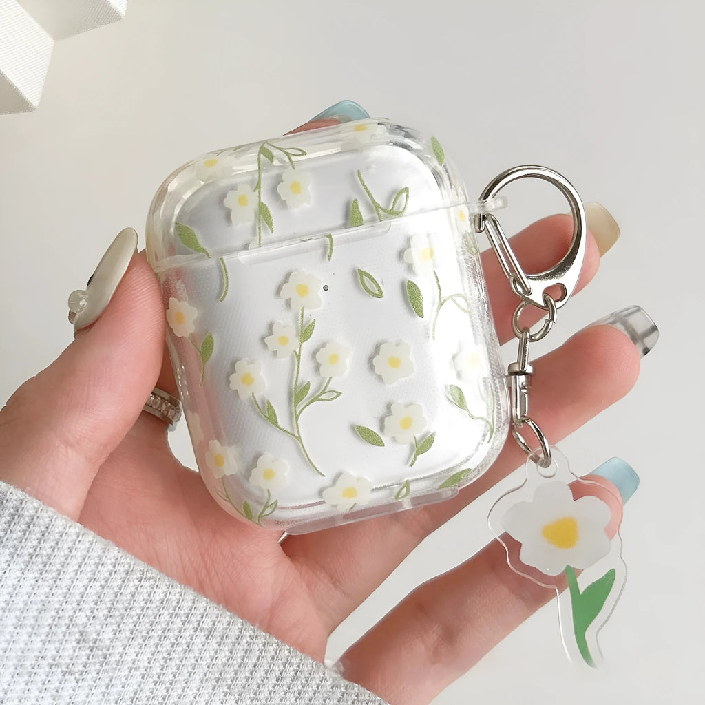 Transparent white floral TPU protective case for Apple AirPods headphones on a table.