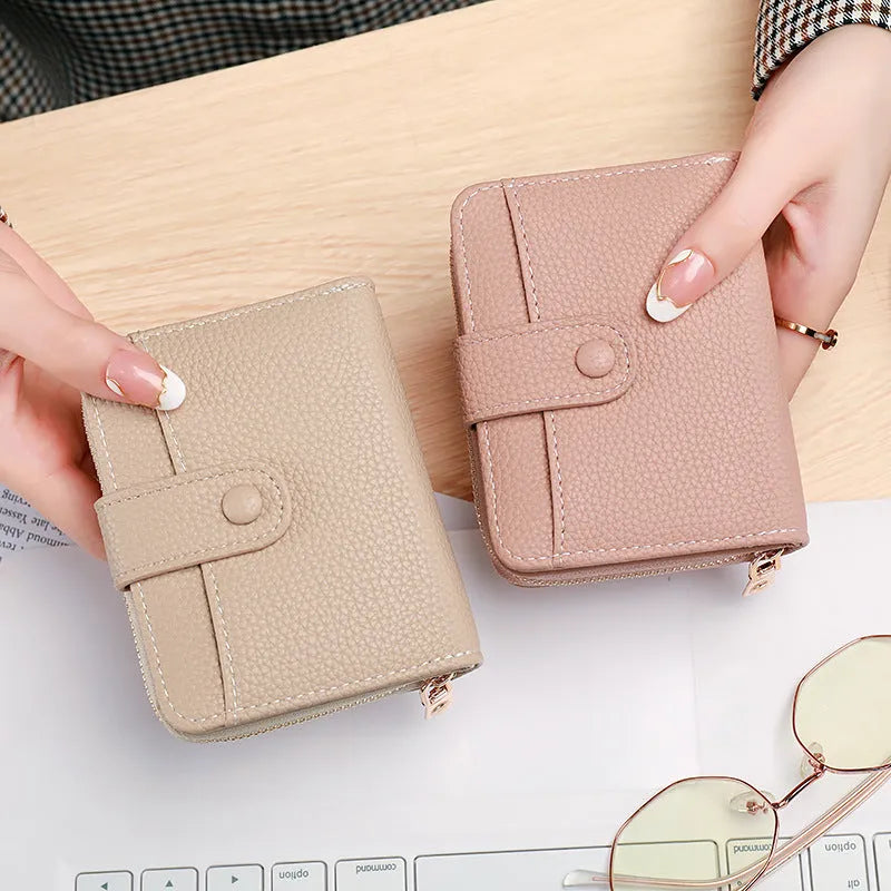 Ladies short wallet with lychee pattern texture in beige, pink, black, or red colours showing two-fold compact design