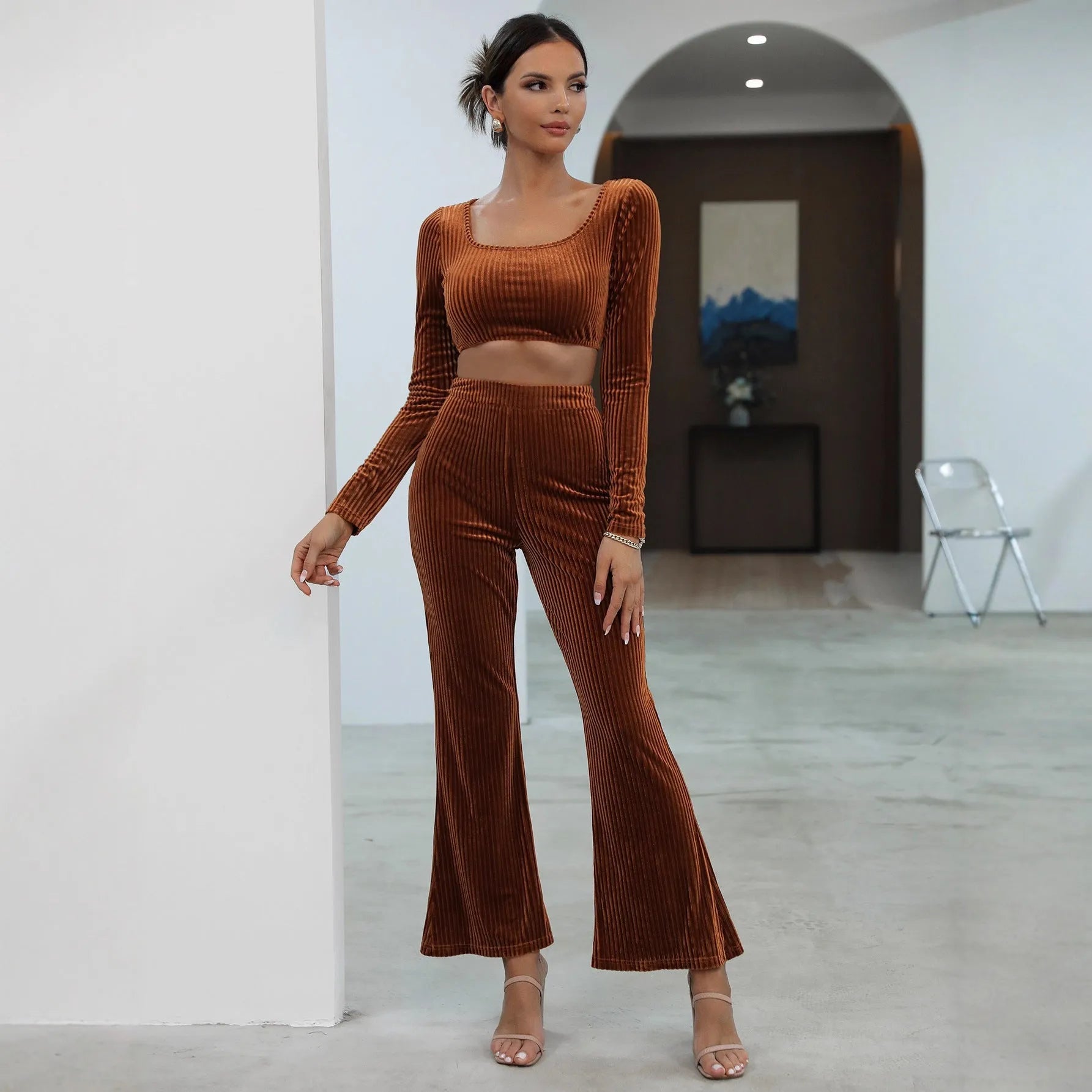 Caramel coloured women's long sleeve sweater and trouser casual set on a hanger.