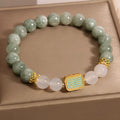 Women's oil green emerald crystal bracelet showing five scripture elements on wrist