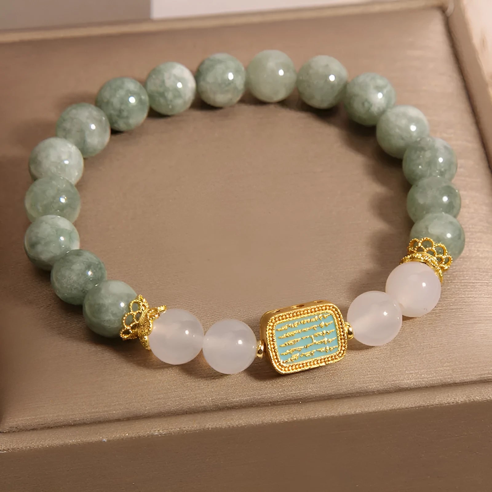 Women's oil green emerald crystal bracelet showing five scripture elements on wrist