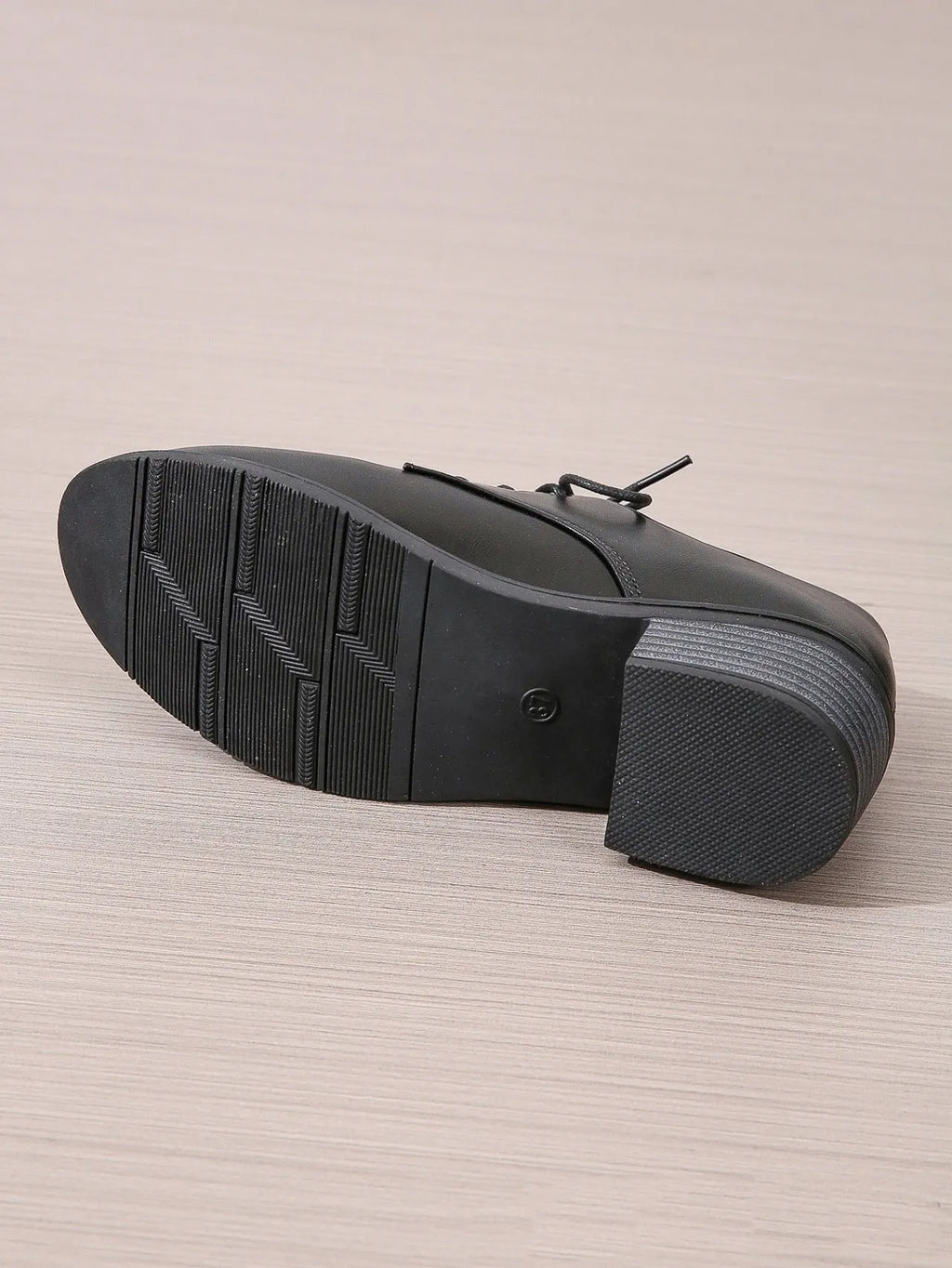 Black women's low-top shoes with a thick chunky heel and rubber sole.