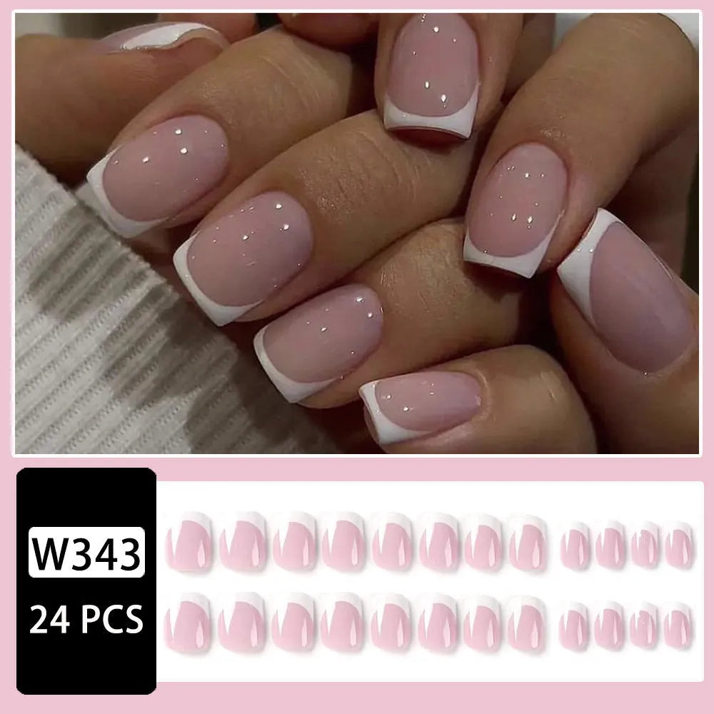 24 white square fake nails with a black and white plaid pattern arranged on a table.