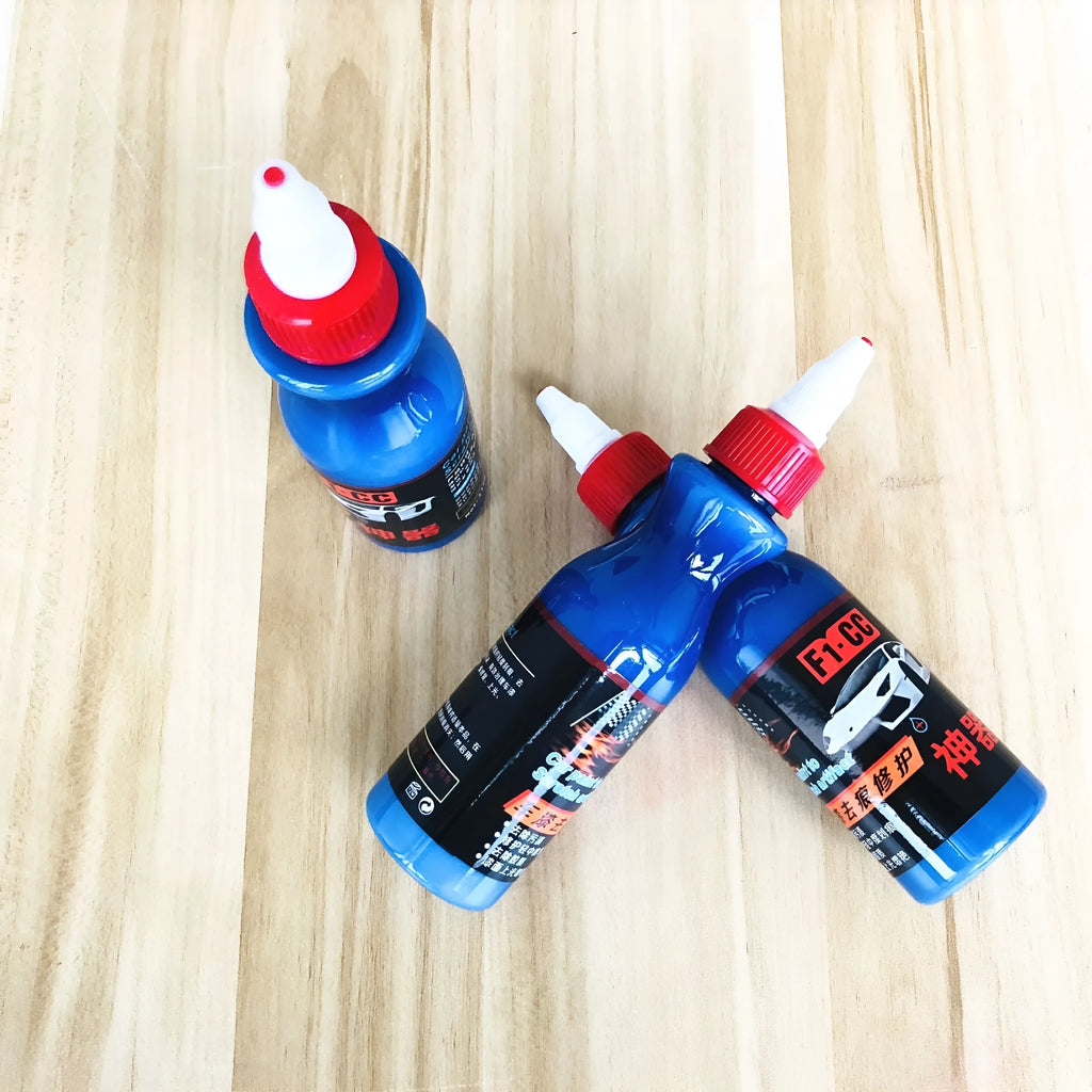 Small blue car scratch repair tool with applicator for automobile surface treatment