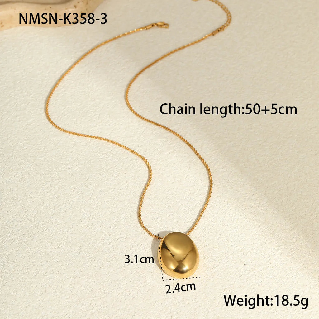Gold-plated geometric necklace with stainless steel chain on display showing pendant detail