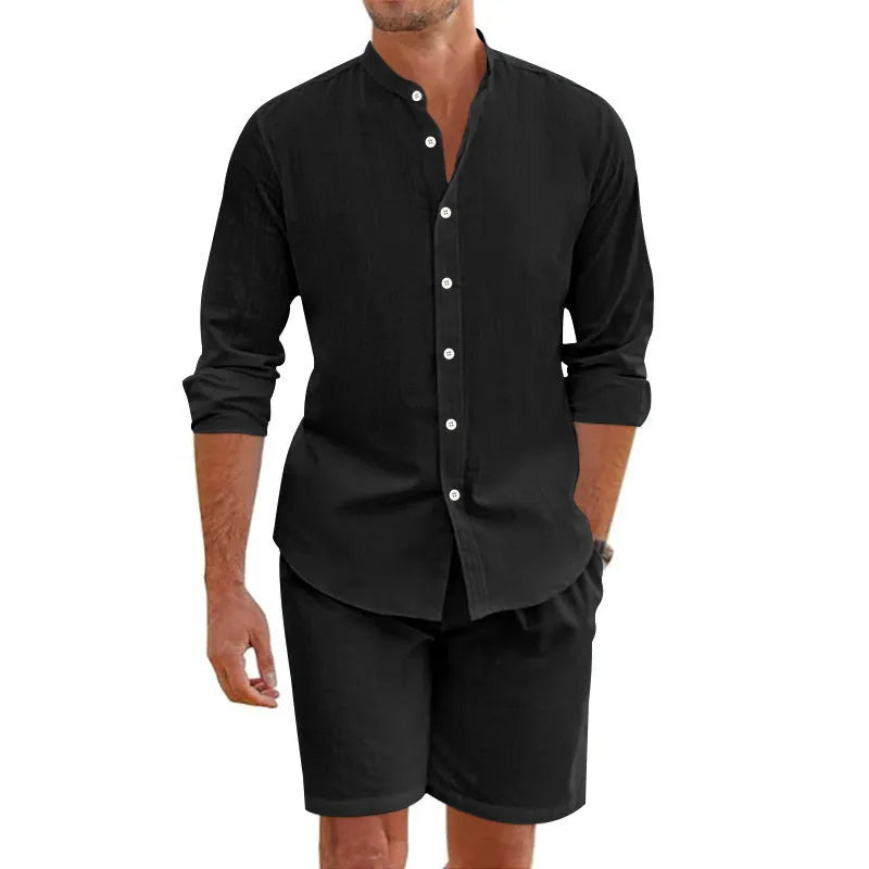 Man wearing a dark grey short-sleeve lapel shirt and matching drawstring shorts from a hemp-blend linen summer suit set.