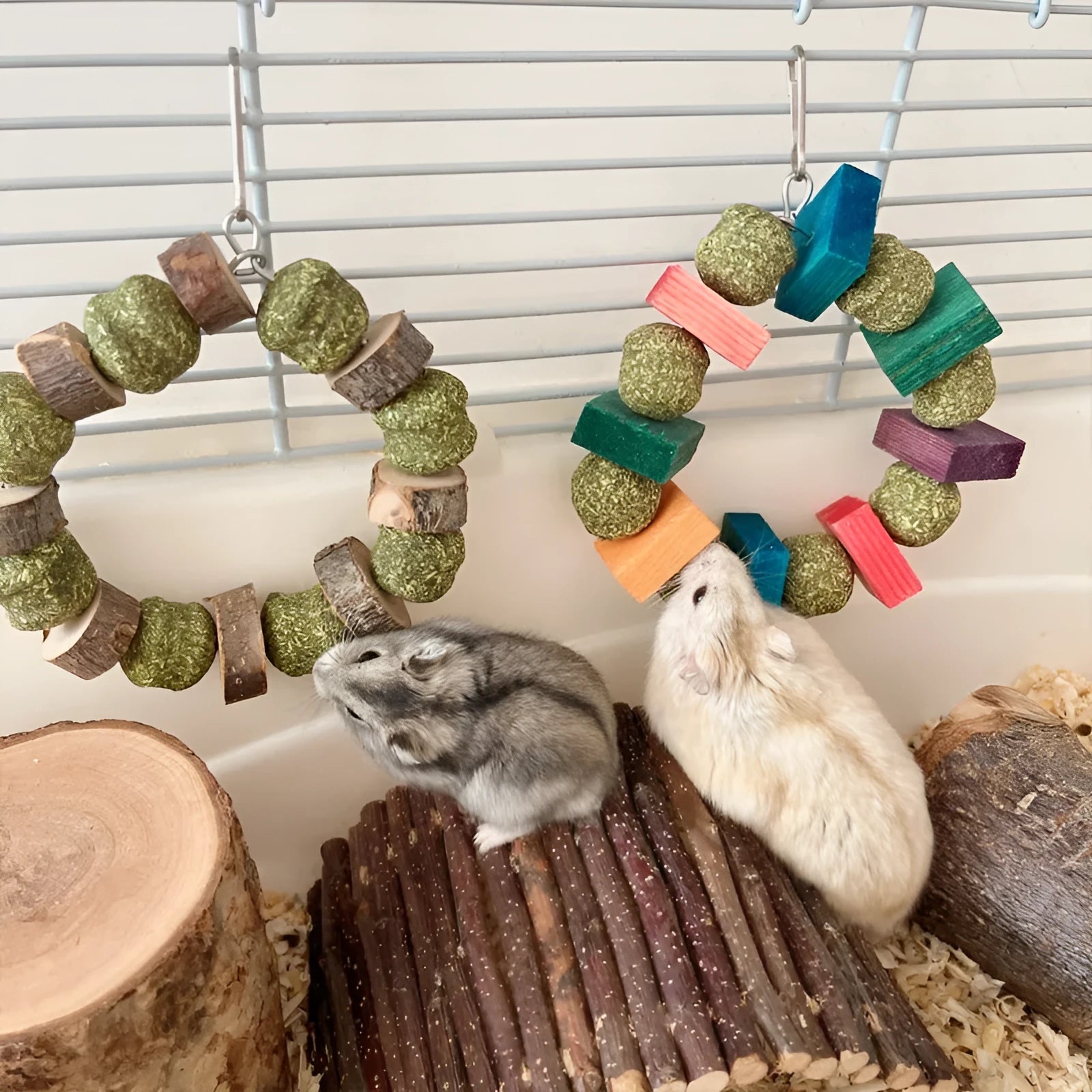 Hamster chew toy featuring an applewood rod with an attached woven straw ball ring.