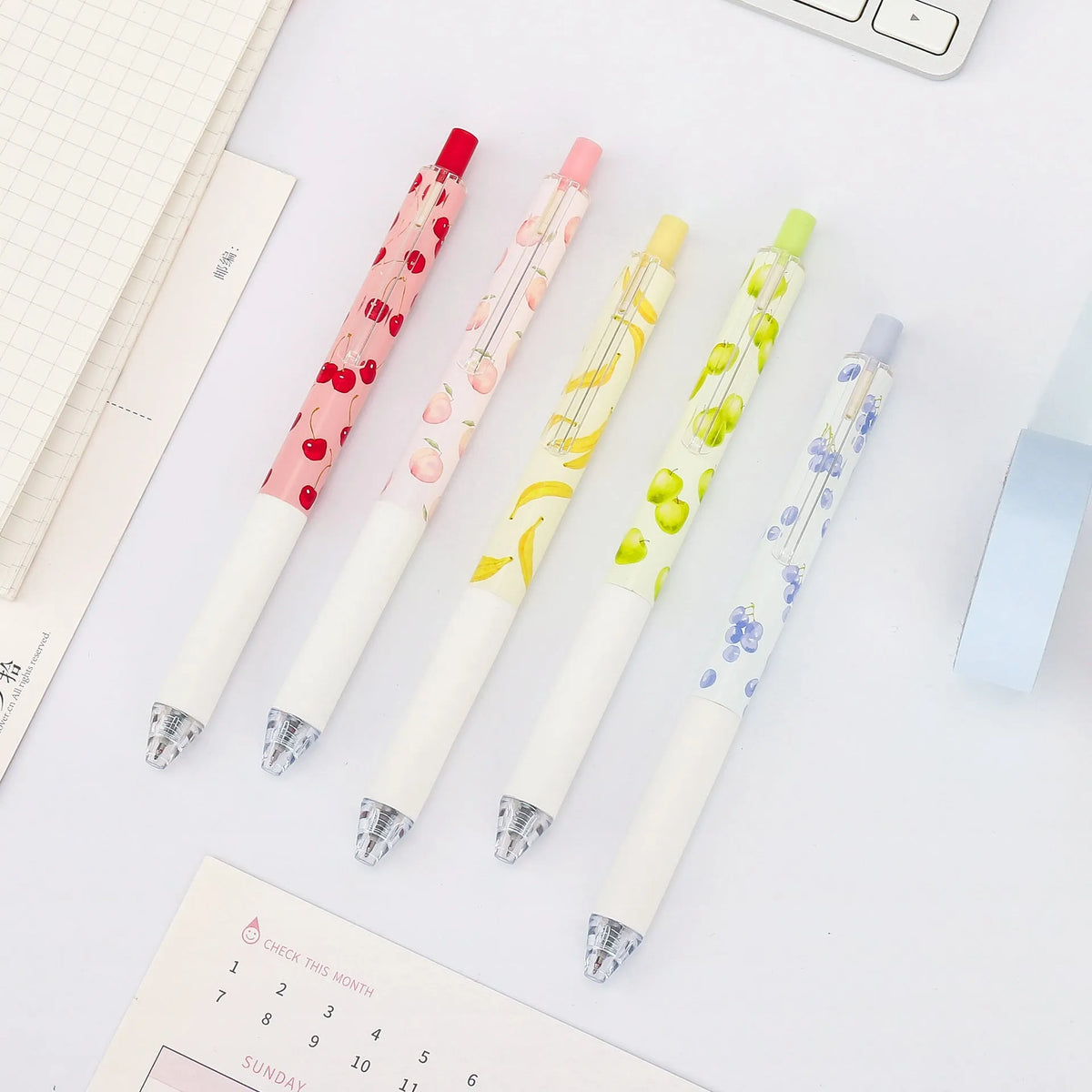 Three fruit-scented pressurised pens with push-button mechanisms and 0.5mm black refills