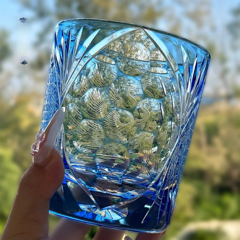 Hand-carved sky blue crystal whiskey shot glass on a wooden surface, 90x100mm size
