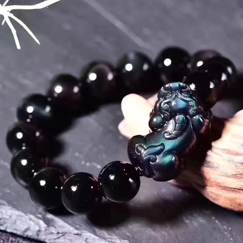 Natural ice colour eye obsidian crystal bead bracelet with spherical beads on wrist.