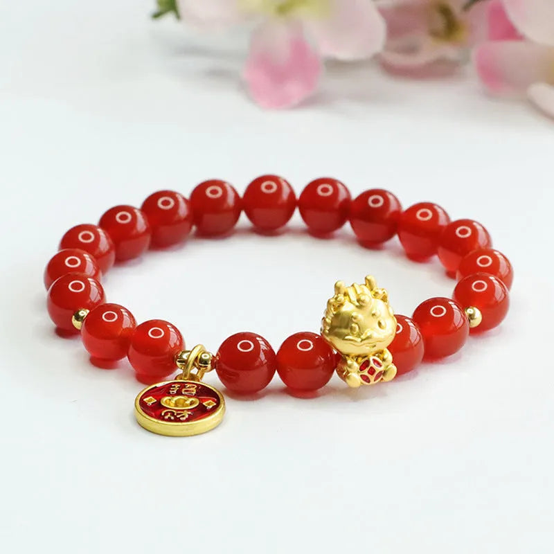 Close-up of a Chinese zodiac dragon bracelet with 8mm red agate beads on a wrist.
