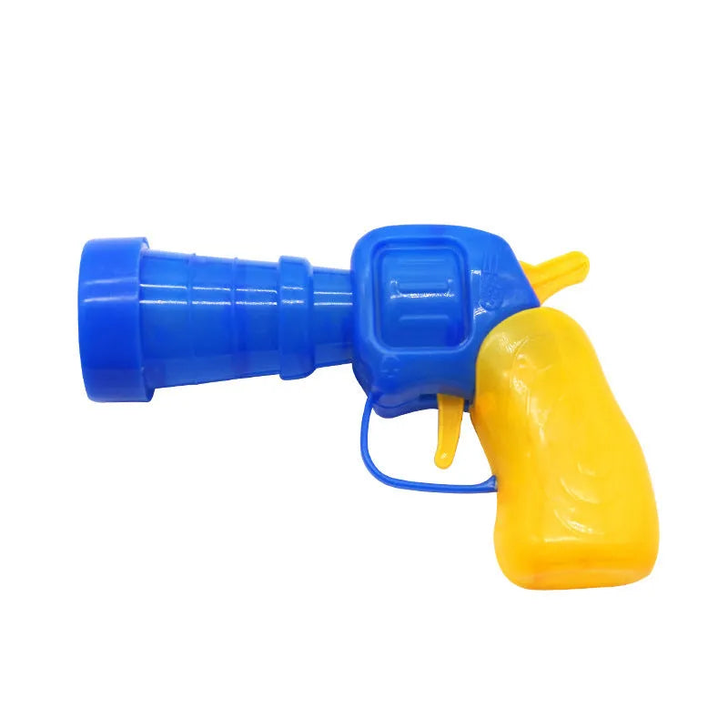 Plush ball launching gun for dogs next to a pile of soft coloured yarn balls.