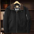 Men's camel coloured washed cotton baseball-style flight jacket on a hanger