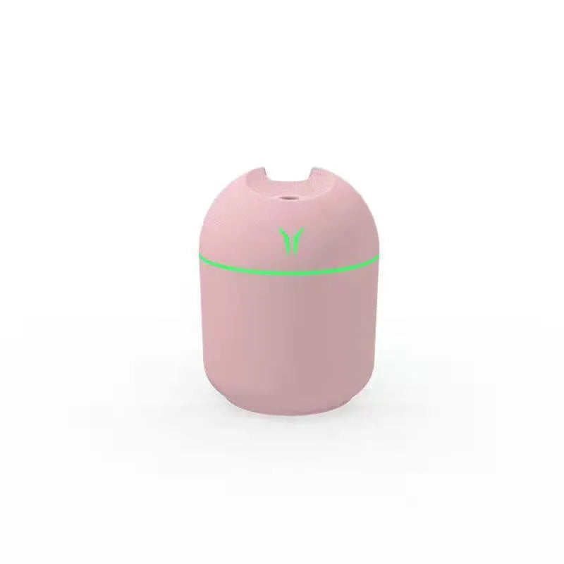 Round desktop humidifier with USB cable in ivory white colour showing mist output