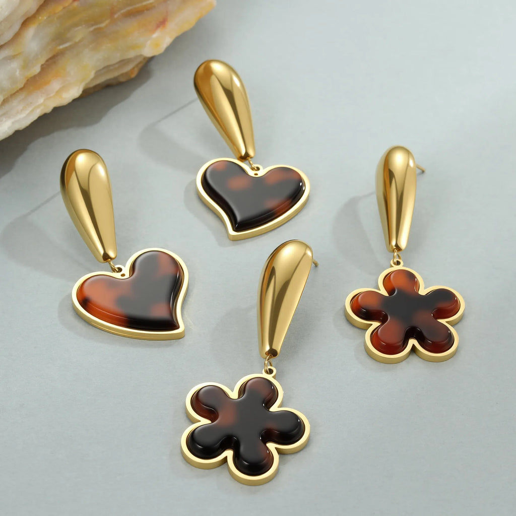 Gold electroplated tortoiseshell resin earrings in heart and flower designs on stainless steel