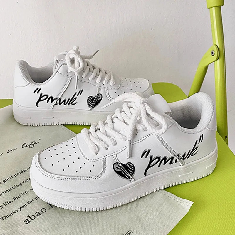 Men's low cut solid colour white casual sports board shoe with PU upper on display