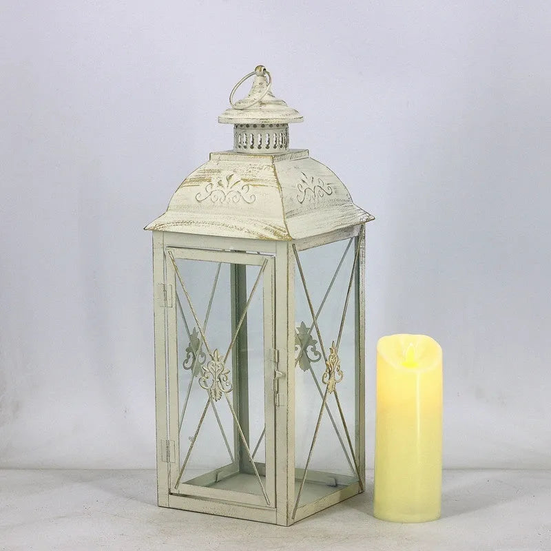 Black and white wrought iron floor-standing storm lantern with tempered glass panels in three sizes for courtyards.