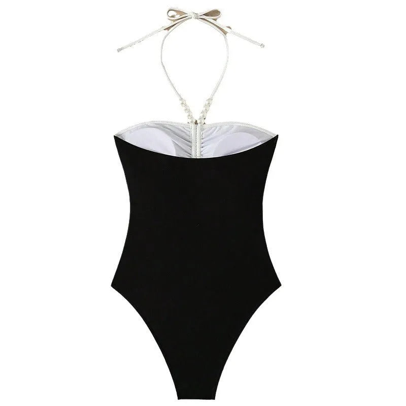 Black and white women's slim fit one-piece swimsuit with pearl spaghetti straps.