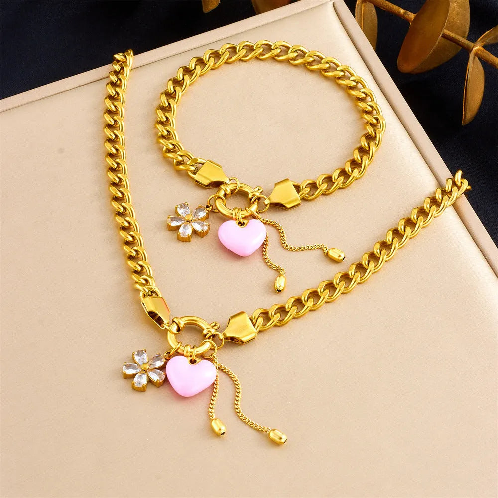 Tassel stainless steel bracelet and necklace set for women with flower and butterfly motifs on a white background