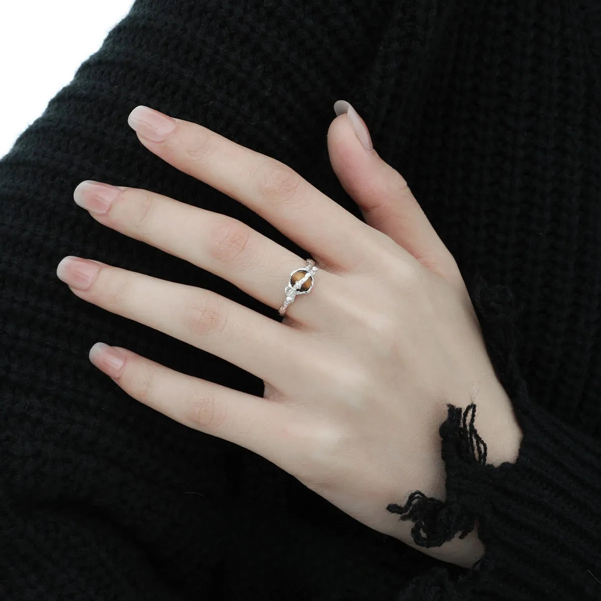 Women's adjustable Saturn design ring in silver with white gold electroplating.