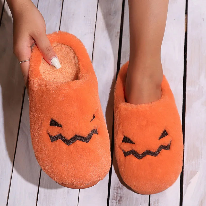 Orange Halloween pumpkin design slippers with plush lining and a textured PVC sole.