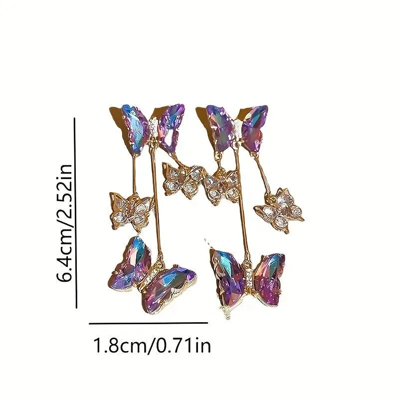 Silver needle alloy drop earrings featuring a blue purple butterfly design with crystal accents and tassel details.