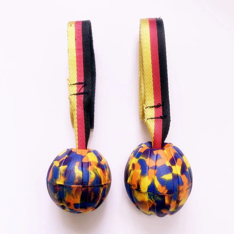 Floating EVA dog training ball with attached string in camouflage or yellow colour options