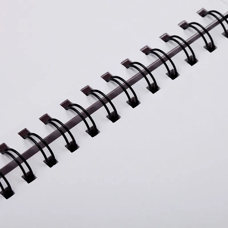 A4 format sketchbook with coil binding and open pages, showing heavy-weight drawing paper.