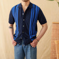 A man wearing a light blue striped short sleeve polo cardigan shirt with a lapel collar.