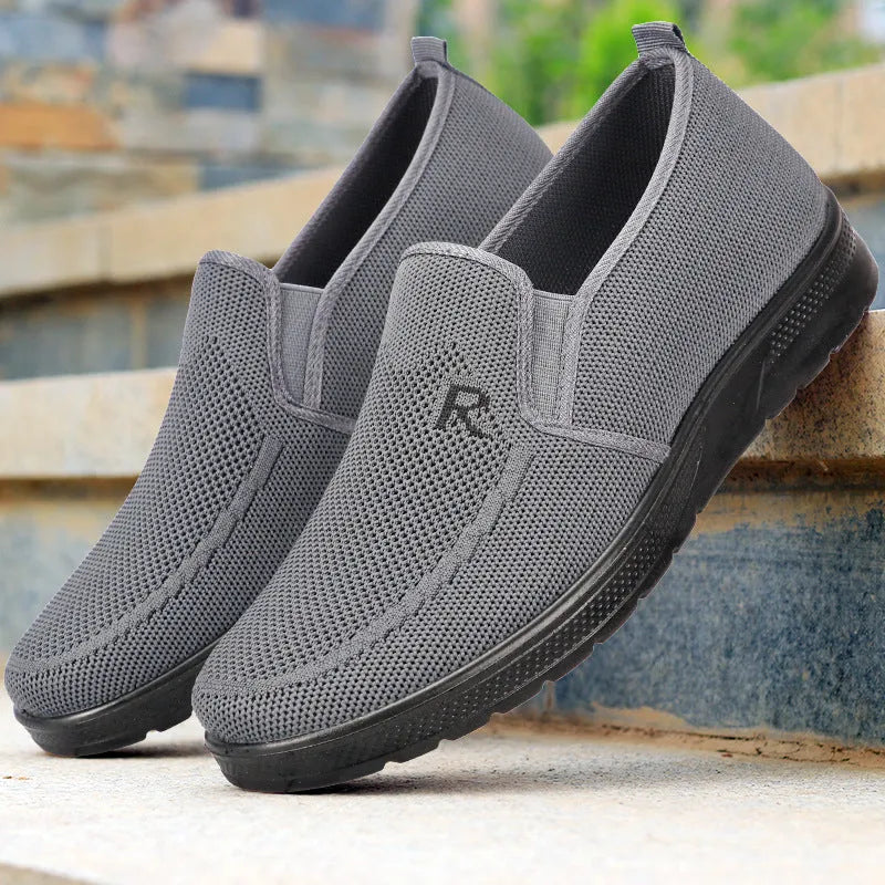 Men's black polyurethane slip-on shoes with breathable mesh upper and flat heel for casual wear