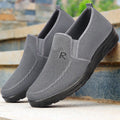 Men's black polyurethane slip-on shoes with breathable mesh upper and flat heel for casual wear