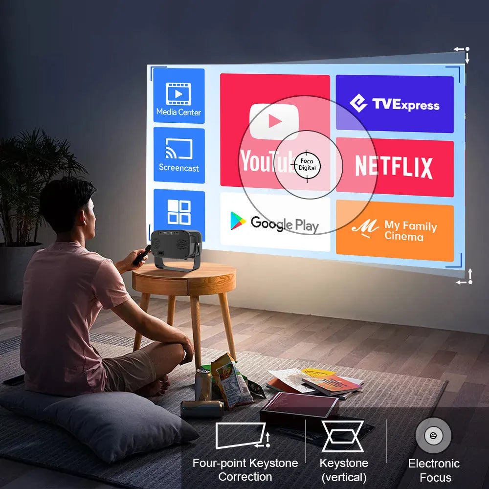 Black portable smart projector with remote control on table
