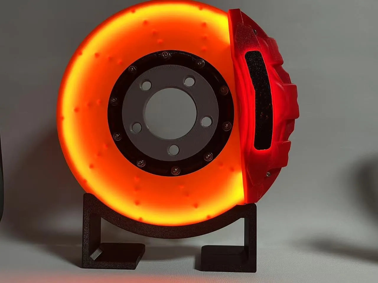 Blue brake disc LED night light with bracket on desk, showing 24cm disc and touch switch