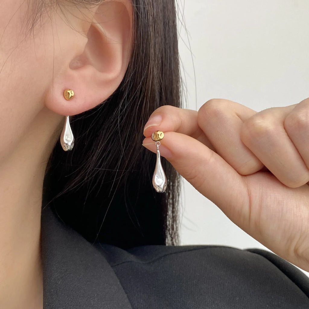 Water drop colour clash copper ear clips with teardrop and geometric shapes on women's ear