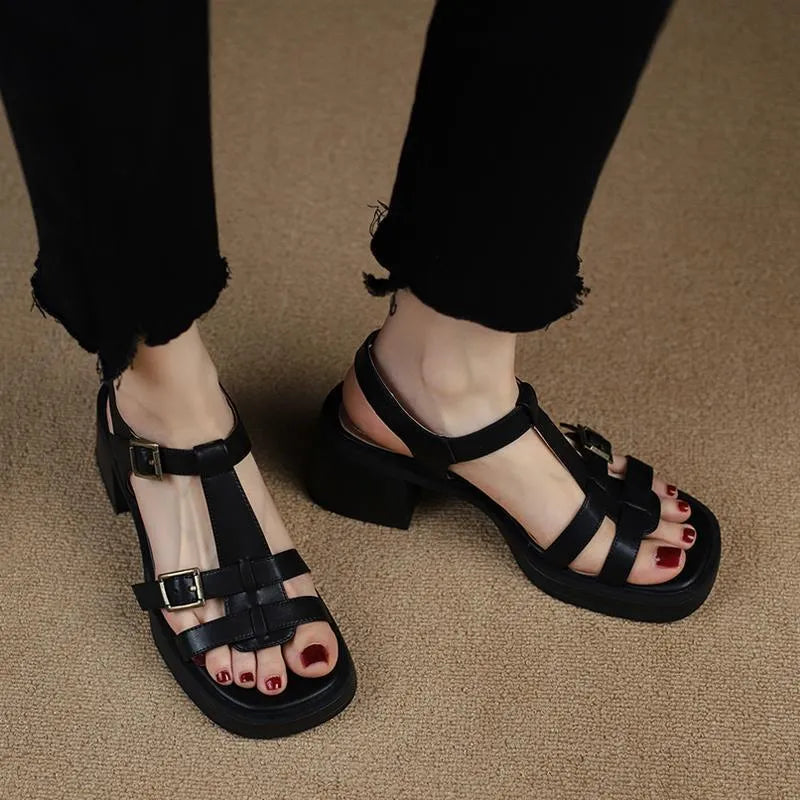 Women's black retro platform sandals with chunky heel and T-buckle strap on a white background.