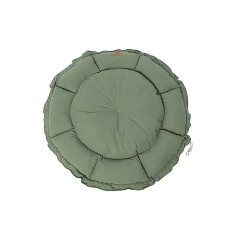 Grey reversible donut-shaped cat bed for indoor pets on a wooden floor.