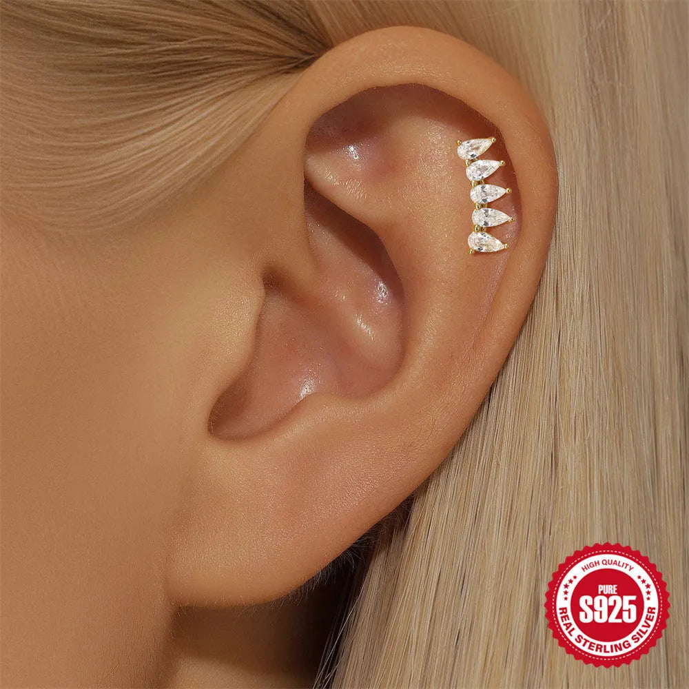 S925 sterling silver moon and star earrings with embedded diamonds on a gold tone background.