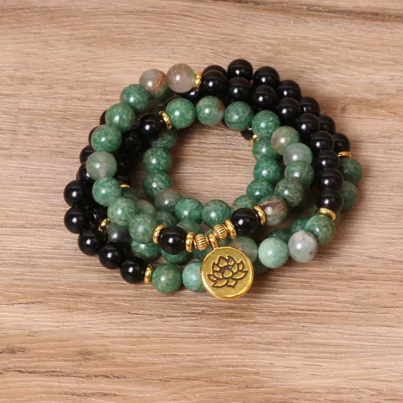 Green and black alloy elastic beaded bracelet showing alternating colours on wrist