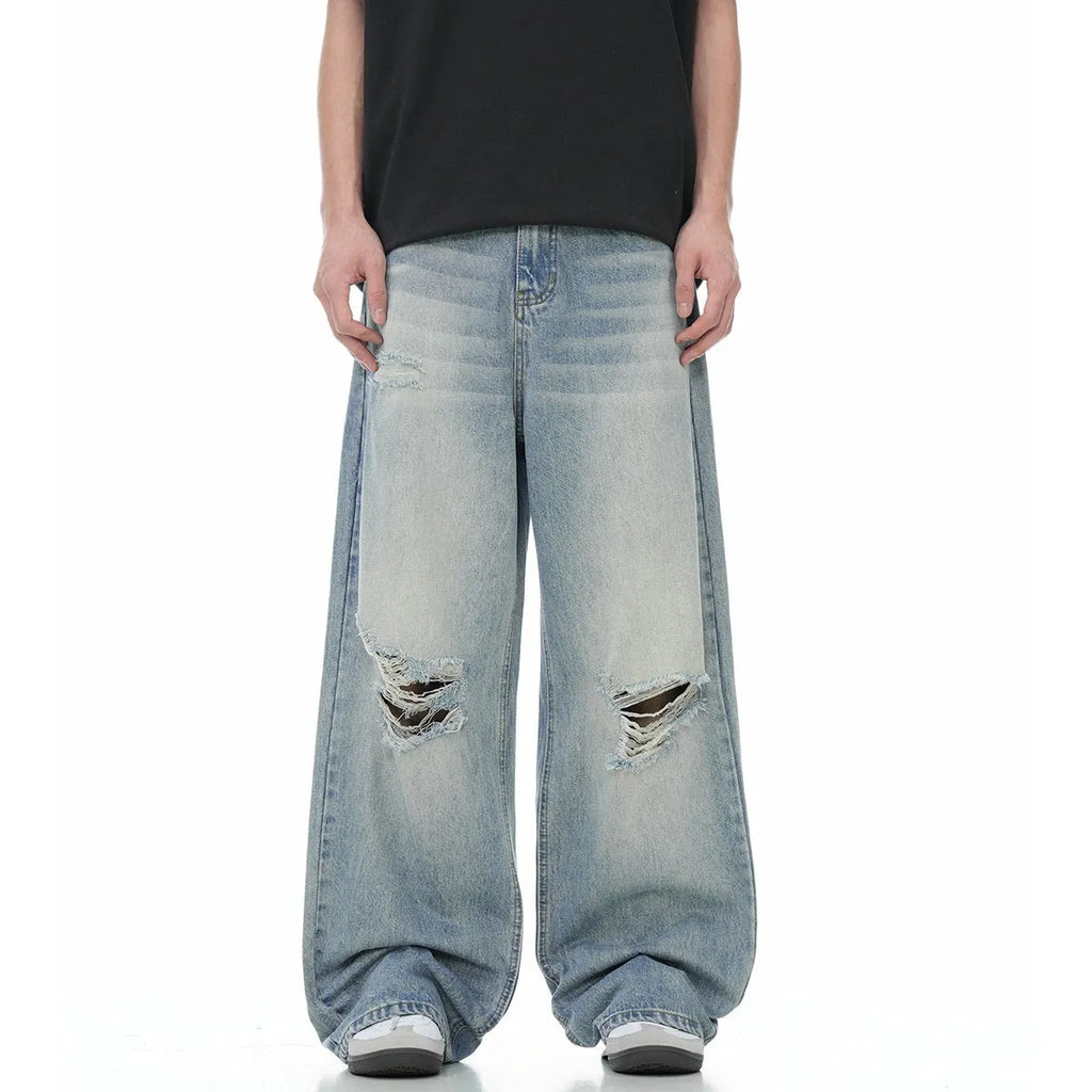 Blue men's straight-leg jeans with ripped details and a zipper fly, showing retro style.
