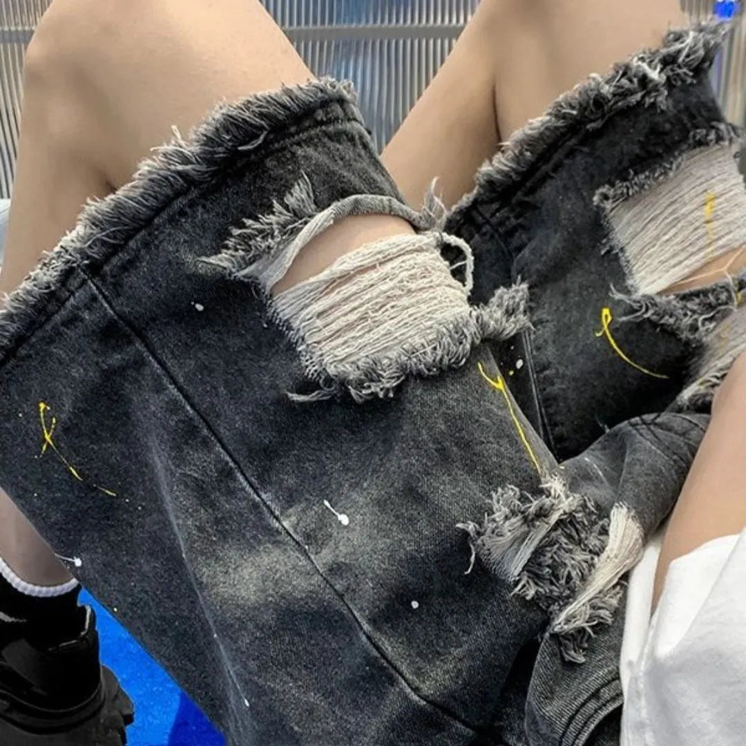 Men's water washed hole denim shorts in loose street style cut, available in black or light blue colours