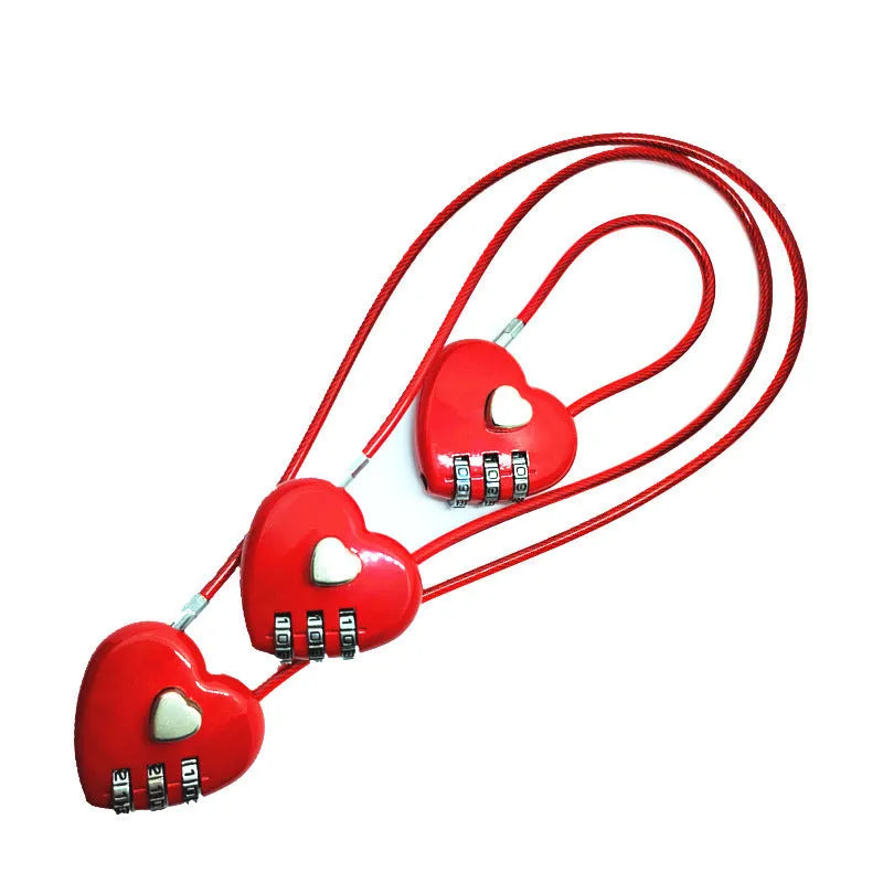 Heart-shaped wire rope lock in various colours with a steel cable, shown securing a bicycle helmet.