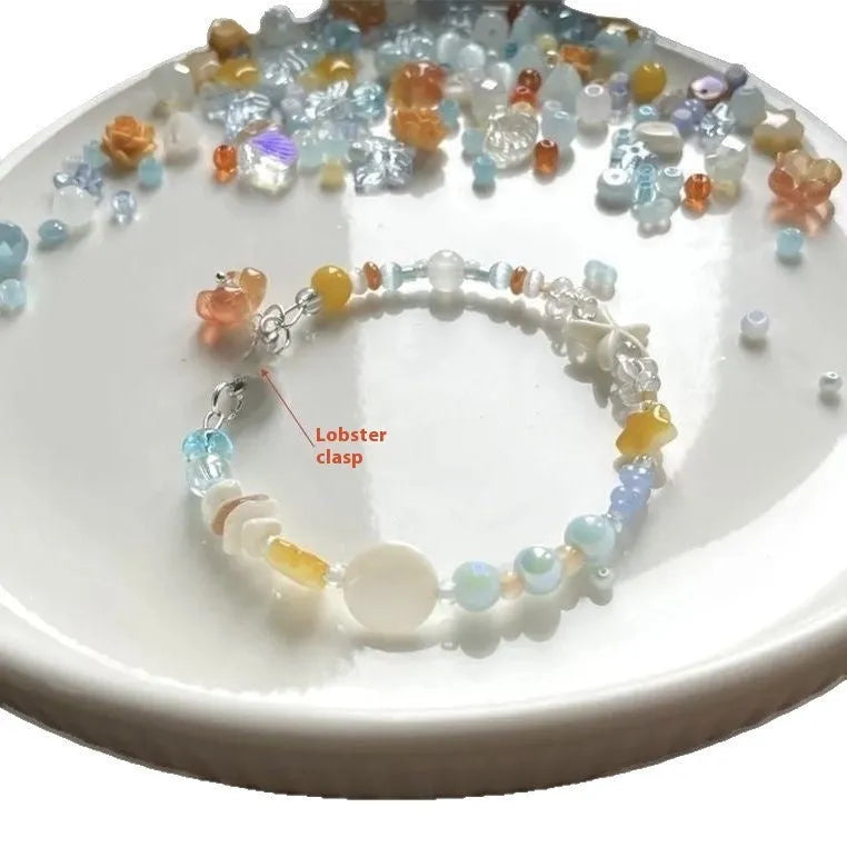 Orange diamond-shaped women's bracelet with round elements, made from mixed materials for summer seaside style.